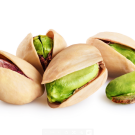Several pistachios with shells and skin on.